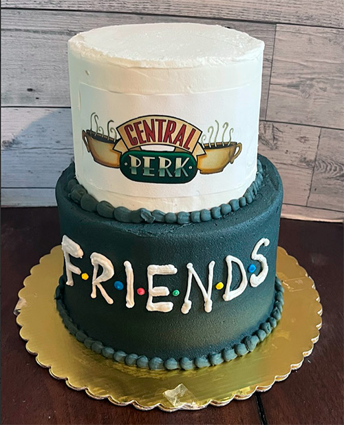 a two tiered cake that has the phrase Central Perk from the show Friends