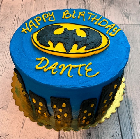 a Bathman themed cake with the batman synbol that says Happy Birthday Dante