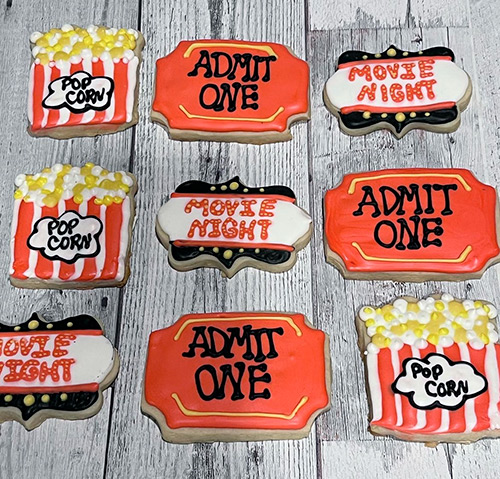 movie theater popcorn and ticket saying admit one decorated sugar cookies