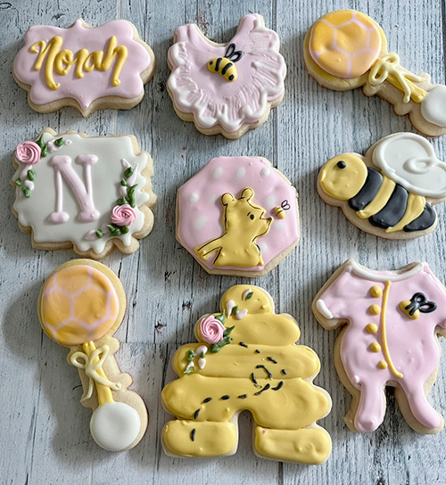 Bees, rattles and beehives decorated sugar cookies for baby Norah