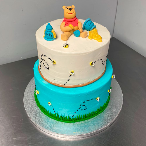 a two tiered Winnie the Pooh inspired cake
