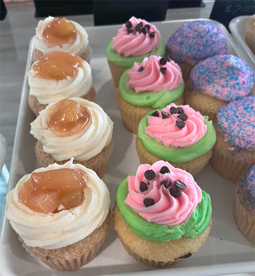 Watermelon cupcakes are display within a variety of other flavos including apple pie and cotton candy
