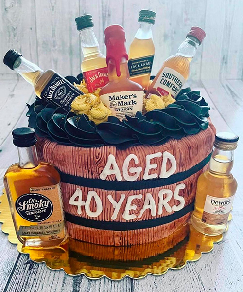 Whiskey themed cake and the words, aged 40 years written on the side